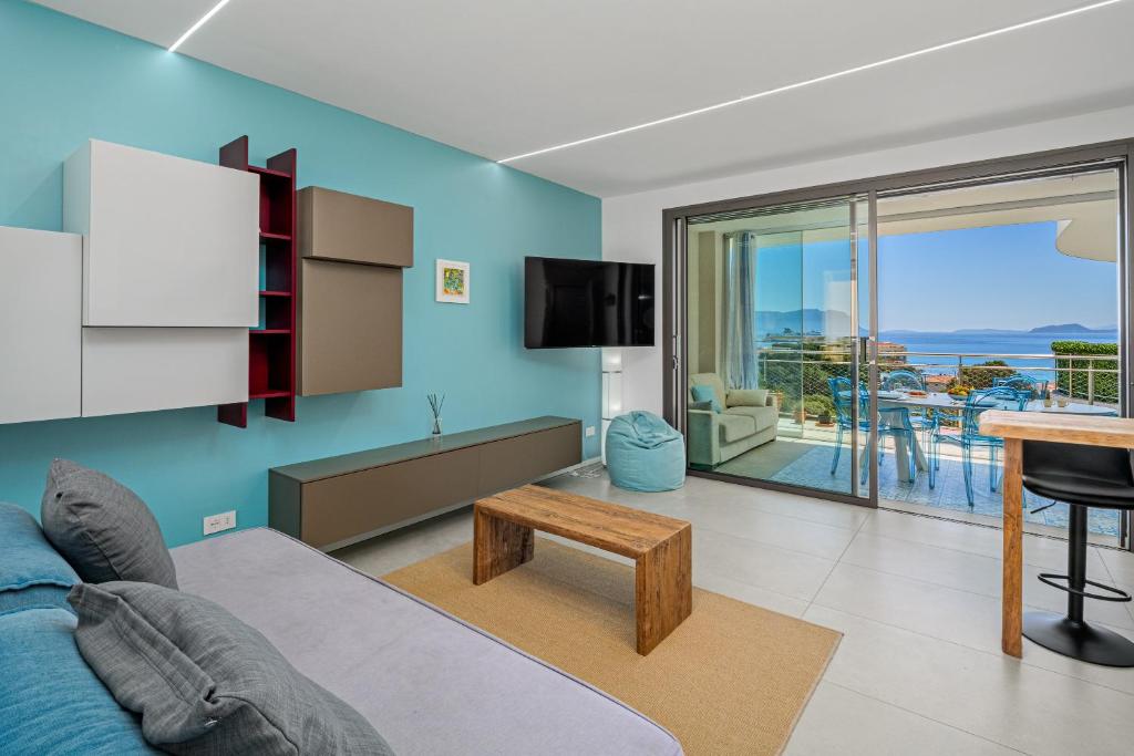 a living room with a couch and a table at Pascoli Suite - by And Service in Golfo Aranci