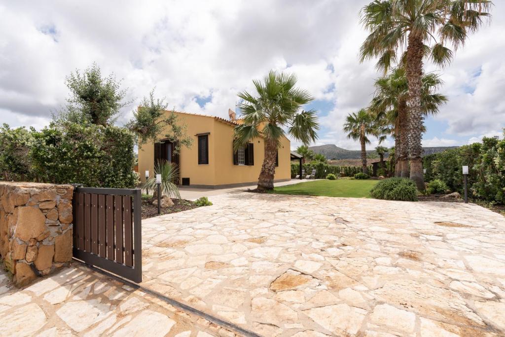 a house with palm trees and a driveway at Summer Spritz in Custonaci