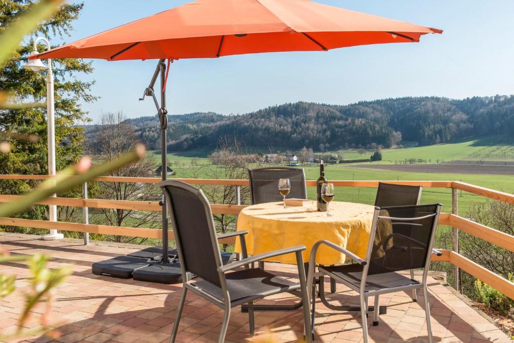 a table and chairs with an umbrella on a patio at Ferienparadies Bodensee Fewo2 in Billafingen