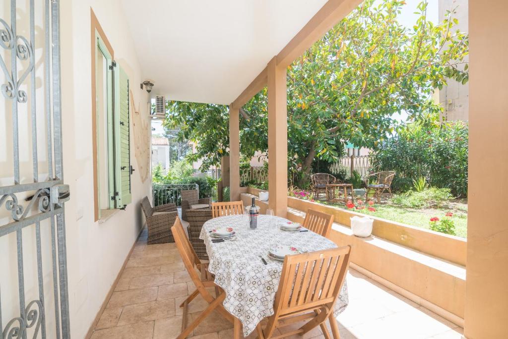 a patio with a table and chairs on a balcony at Maison Chloe in La Maddalena
