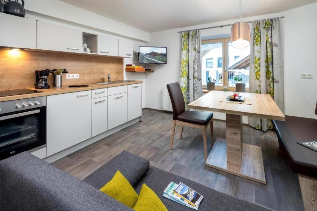a kitchen and living room with a table and a dining room at Haus Sabrina Masnerjoch in See
