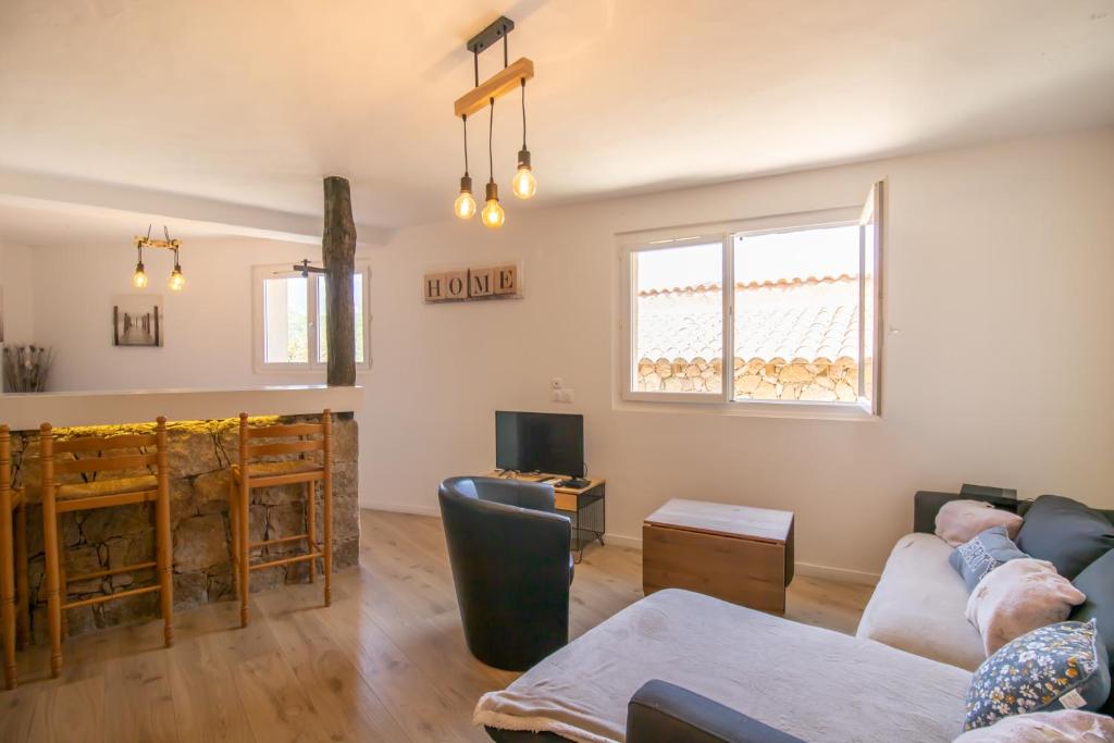 a living room with a couch and a fireplace at Villa Solsticia in Albitreccia