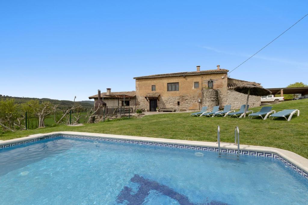 a large swimming pool in front of a house at Casamira in Sagás