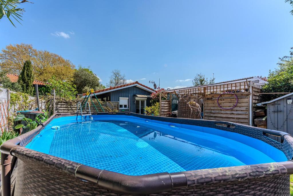 a swimming pool in the backyard of a house at Chalet studio bassin d'Arcachon in La Teste-de-Buch