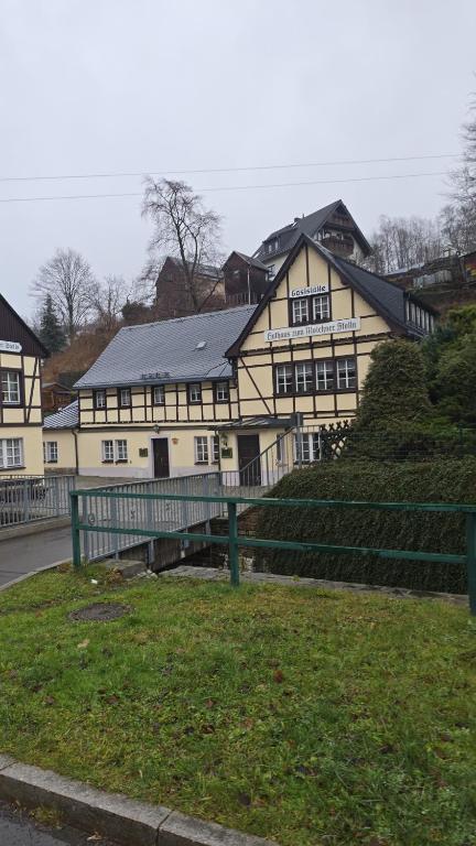 a large white building with a black roof at Huthaus zum Molchner Stollen in Pobershau