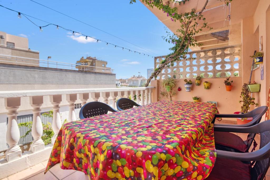 a table with a colorful blanket on a balcony at Oliva Avinyo in Oliva