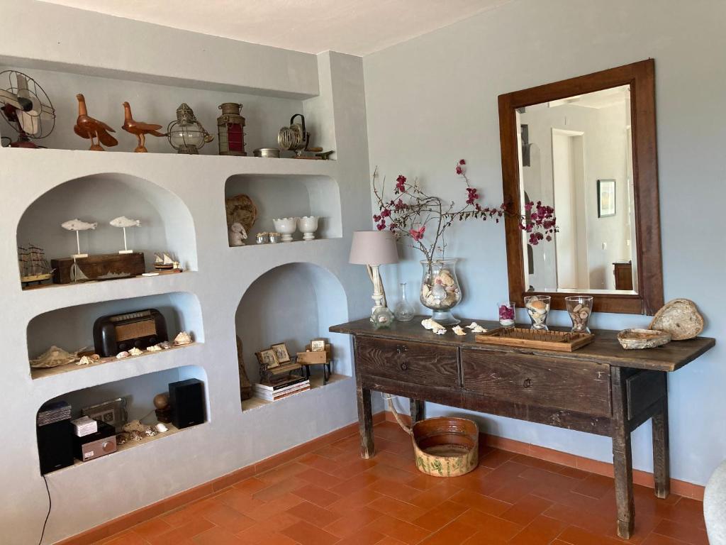 a room with a table and a mirror and shelves at Country House With Private Pool in Tavira