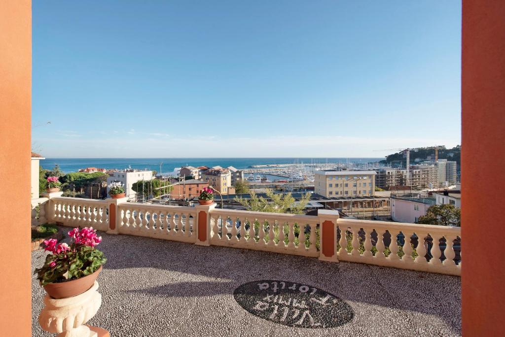 a balcony with flowers and a view of the city at Trilocale in villa Apt 5 in Varazze