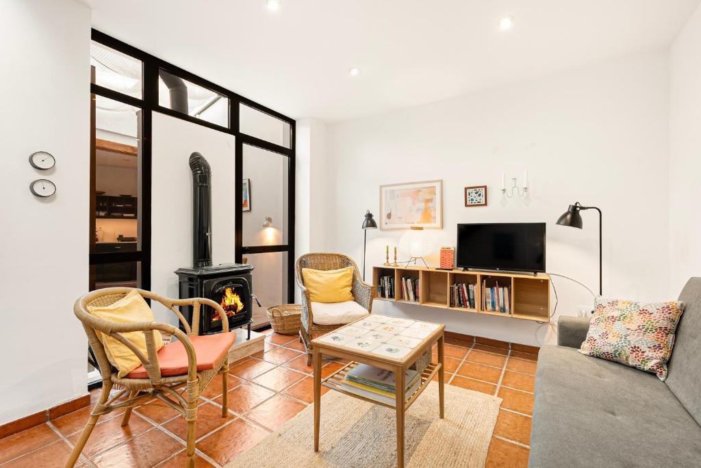 a living room with a couch and chairs and a fireplace at Casa Limón in Vélez-Málaga