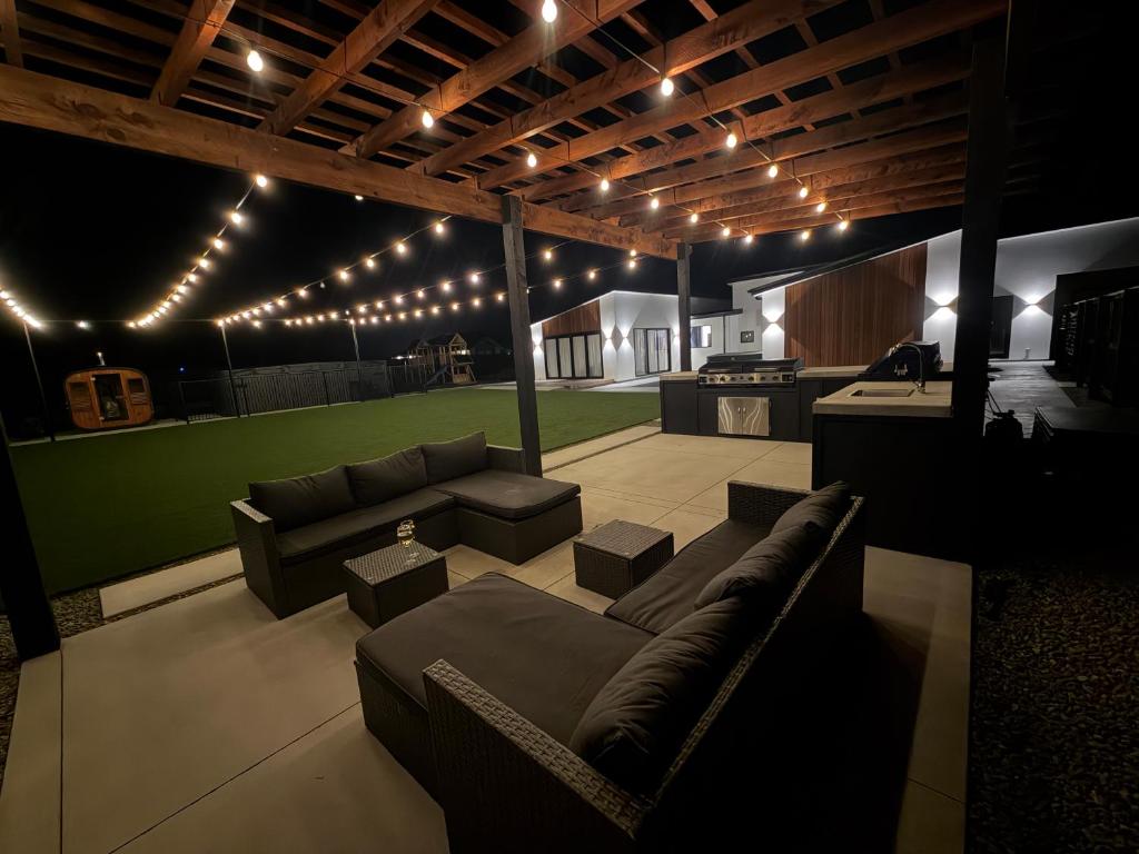 a living room with a couch and a table and lights at Darfield Retreat in Darfield