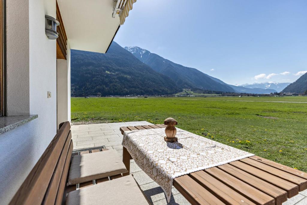 a teddy bear sitting on a table on a patio at Peintenhof Typ A in Sand in Taufers