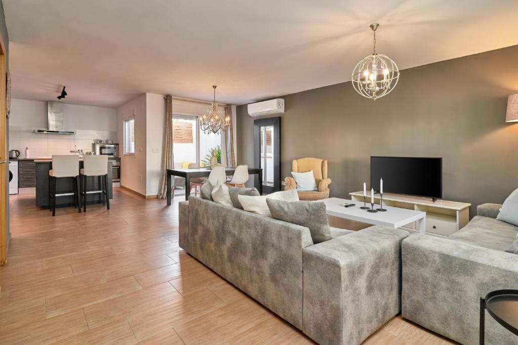 a living room with a couch and a table at Almijarahouse in Nerja