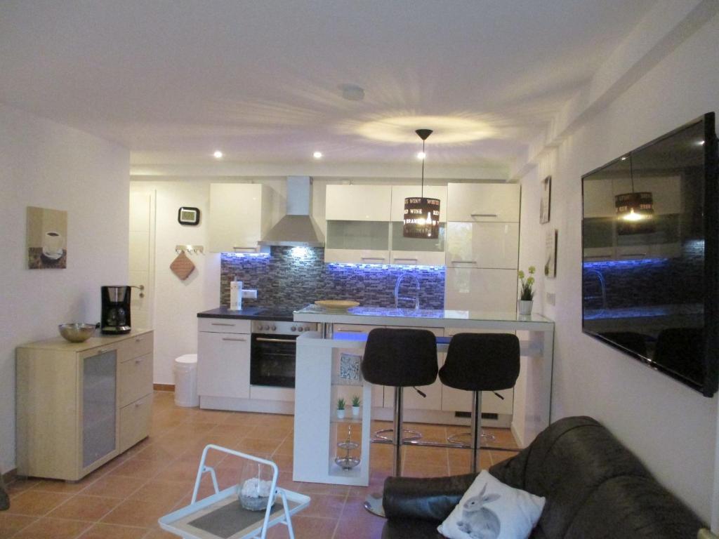 a kitchen with a couch and chairs in a room at Ferienwohnung am Sulzbach in Sulzburg