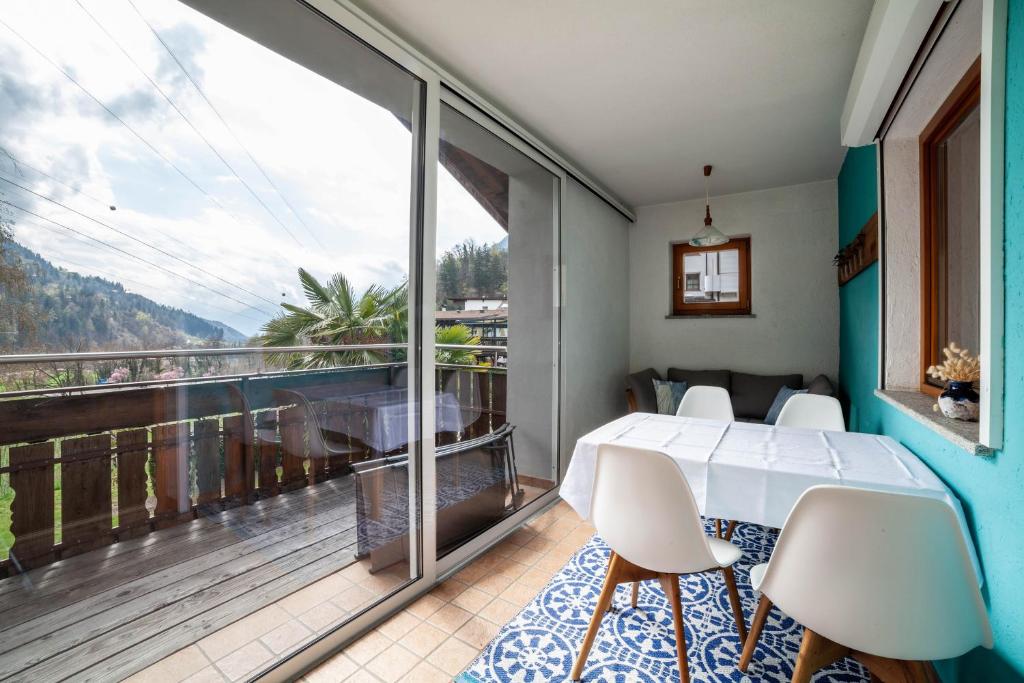 a bedroom with a bed and a balcony with a view at Camping Passeier Arnika in Saltusio