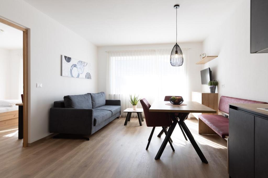 a living room with a couch and a table at Kleon 2 in Rifiano