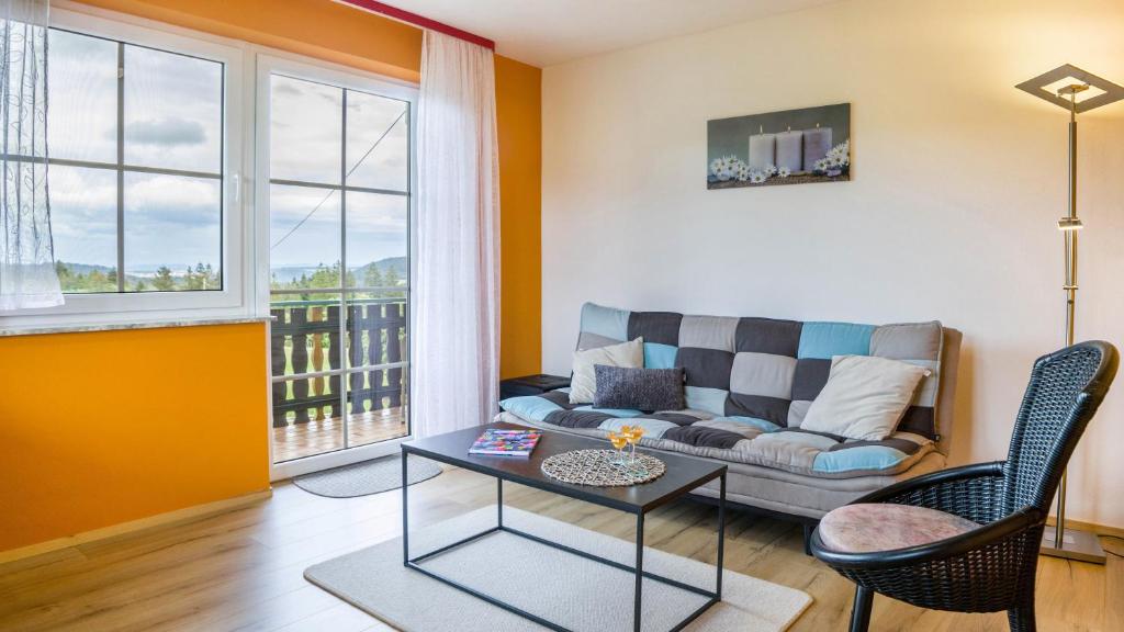 a living room with a couch and a table at Fewo Fuchs in Lauterbach