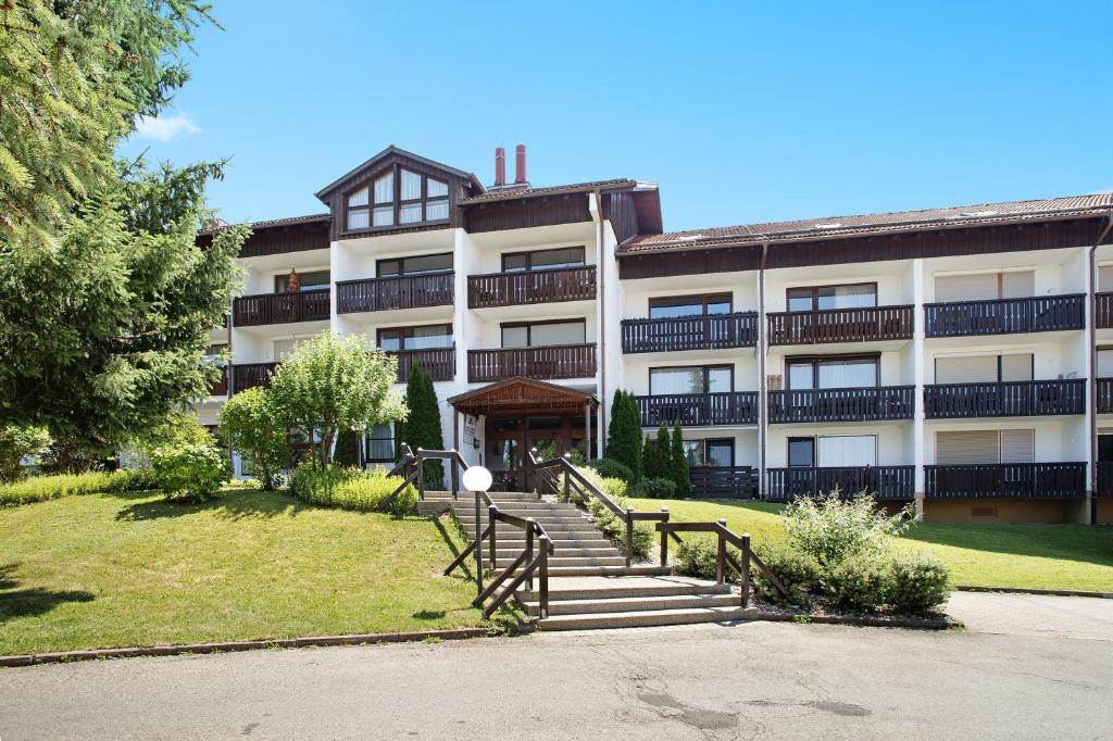 an apartment building with a staircase in front of it at Wanderglück in Missen-Wilhams