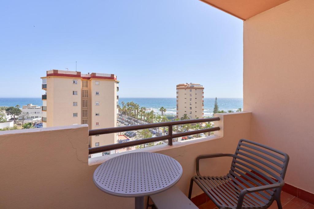 a balcony with a table and a view of the ocean at Casa Bellota in Torrox