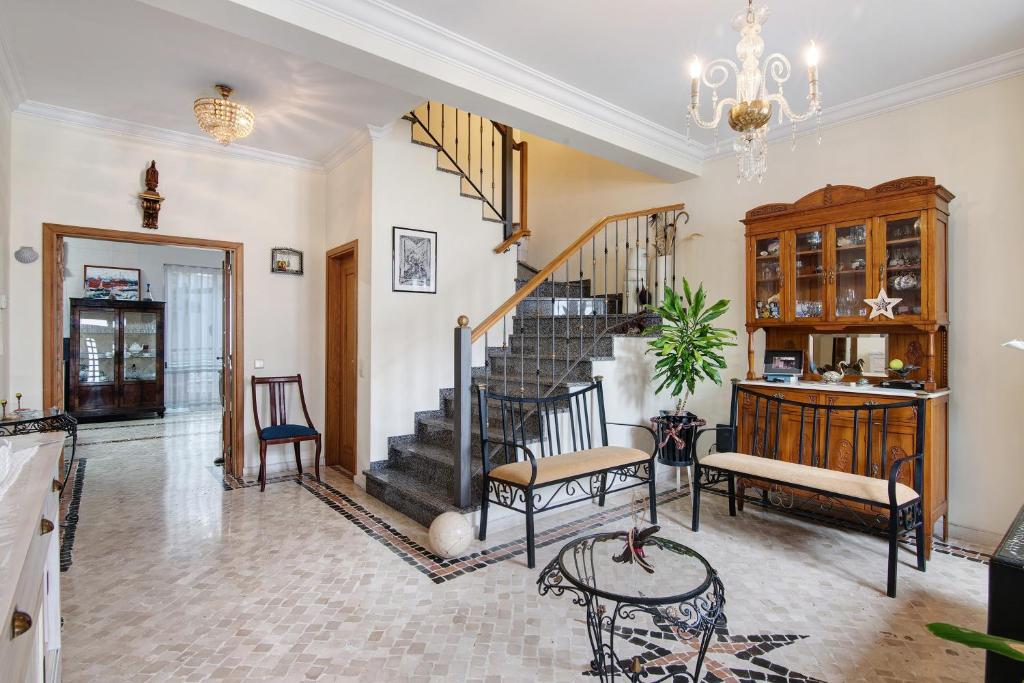 a living room with a staircase and a table at Casa da Cidade de Loulé in Loulé