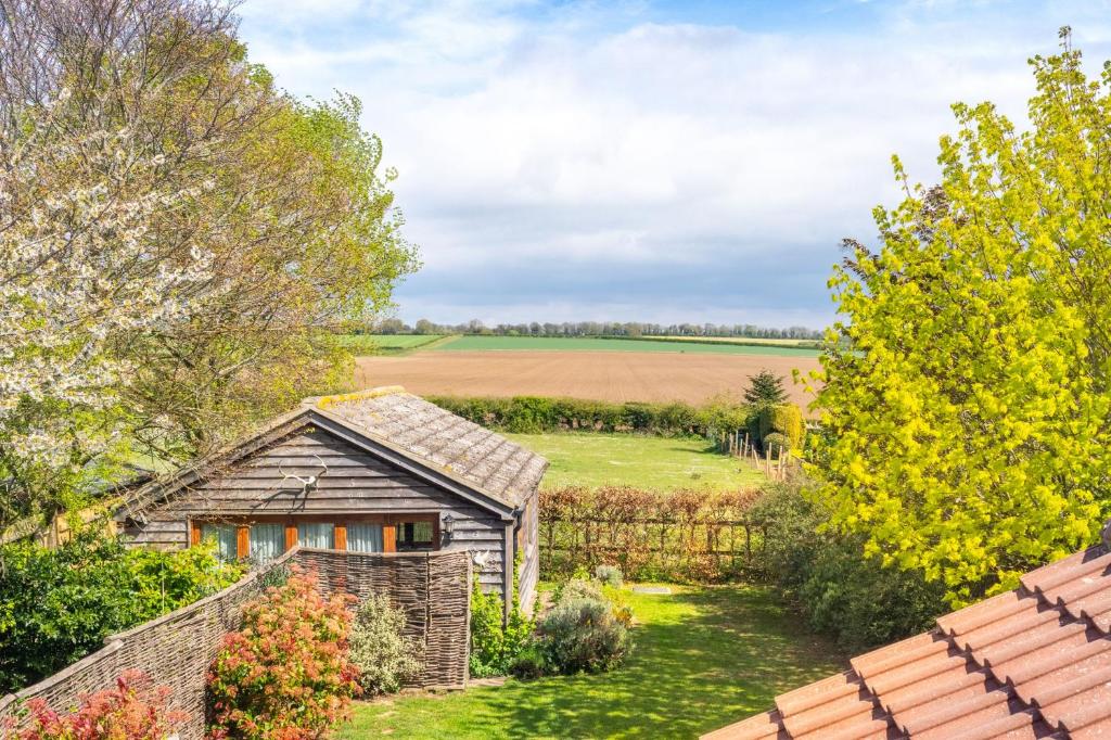 an old house in the middle of a field at The Bothy in Ringstead