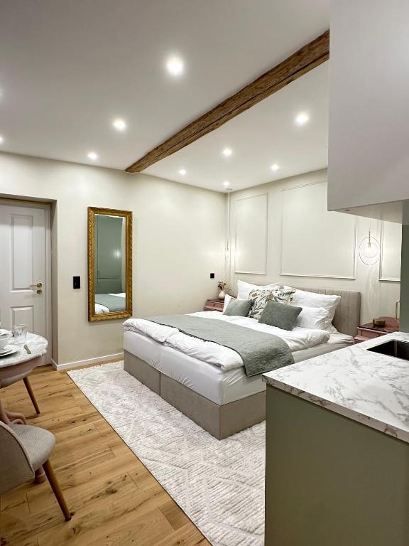 a bedroom with a large bed and a kitchen at Fewo Sand 10 - Altstadtstudio in Bamberg