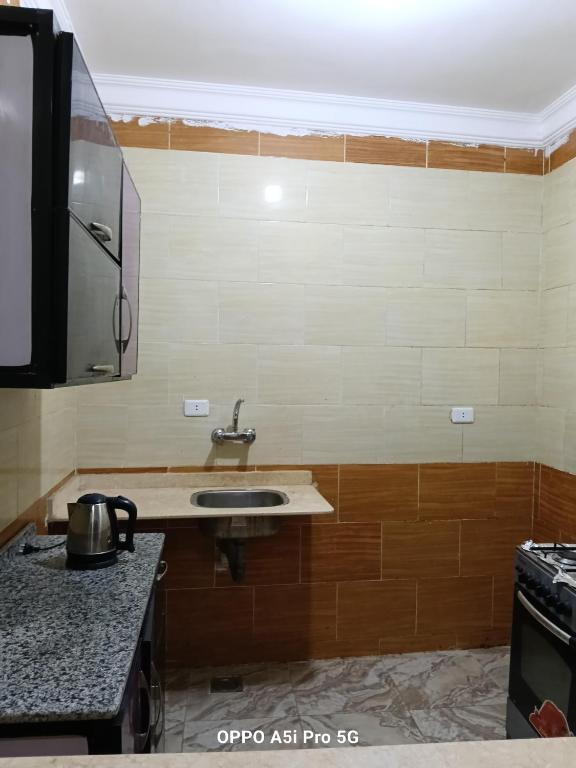 a kitchen with a sink and a counter at 2 rooms, 2 balconies in Marsa Alam City