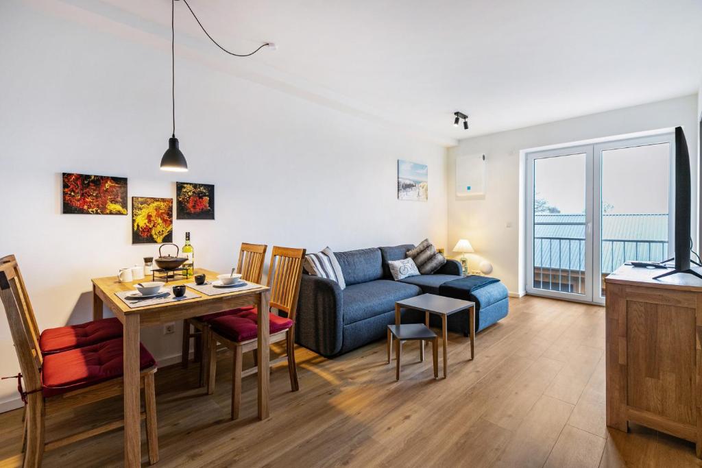 a living room with a couch and a table at Snorrum Wohnung 7 in Husby