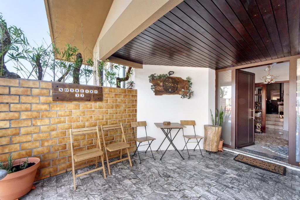 a restaurant with a brick wall and a table and chairs at Sobreiro22 in Lourosa