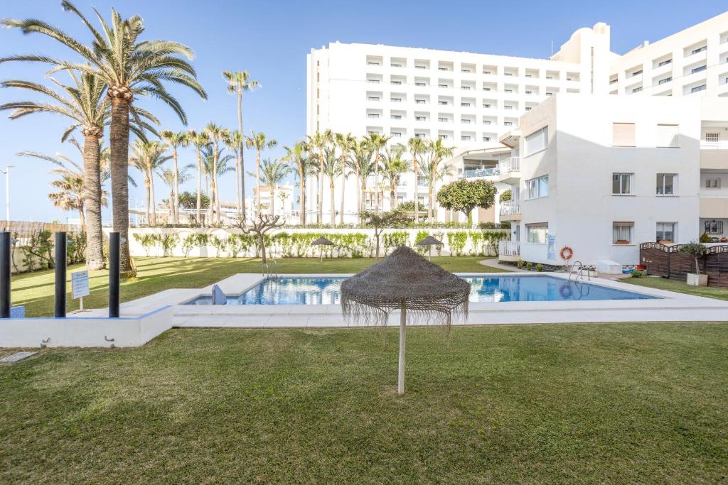 a view of the pool at the resort with palm trees at Torresol 208 in Nerja