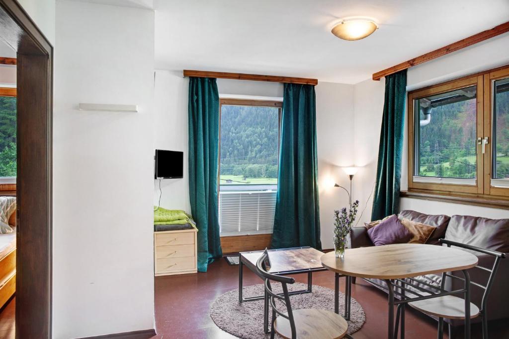 a living room with a table and a couch at Sonnberg in Stall