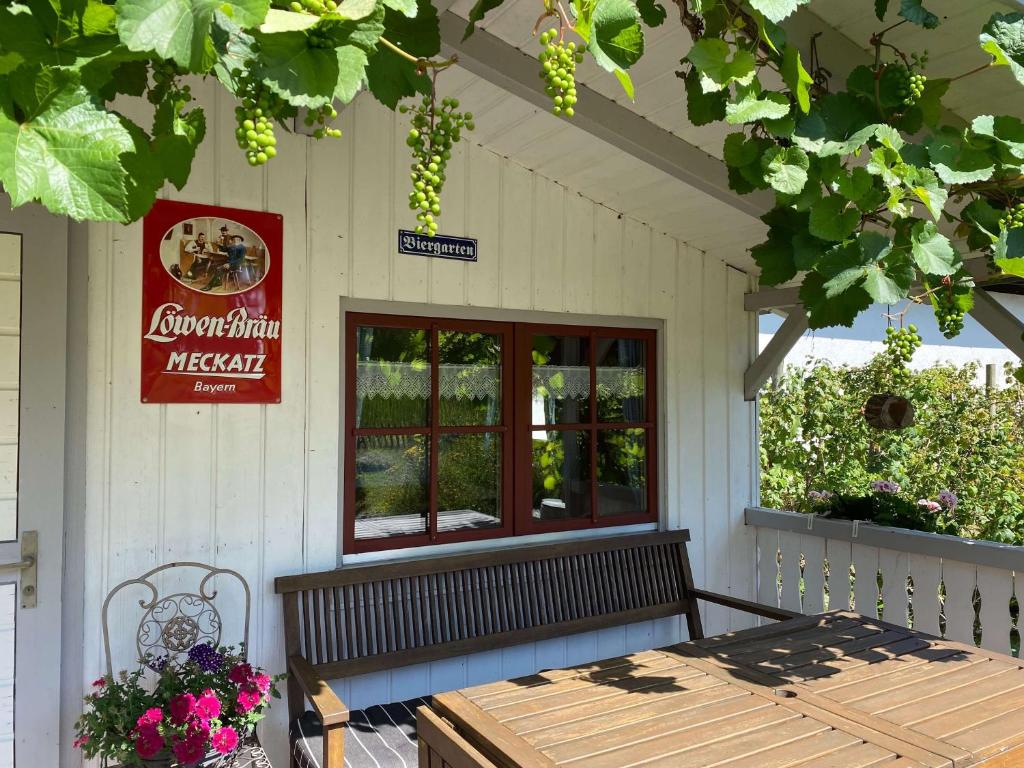 a bench sitting on the porch of a restaurant at Bei Dörflingers in Klettgau