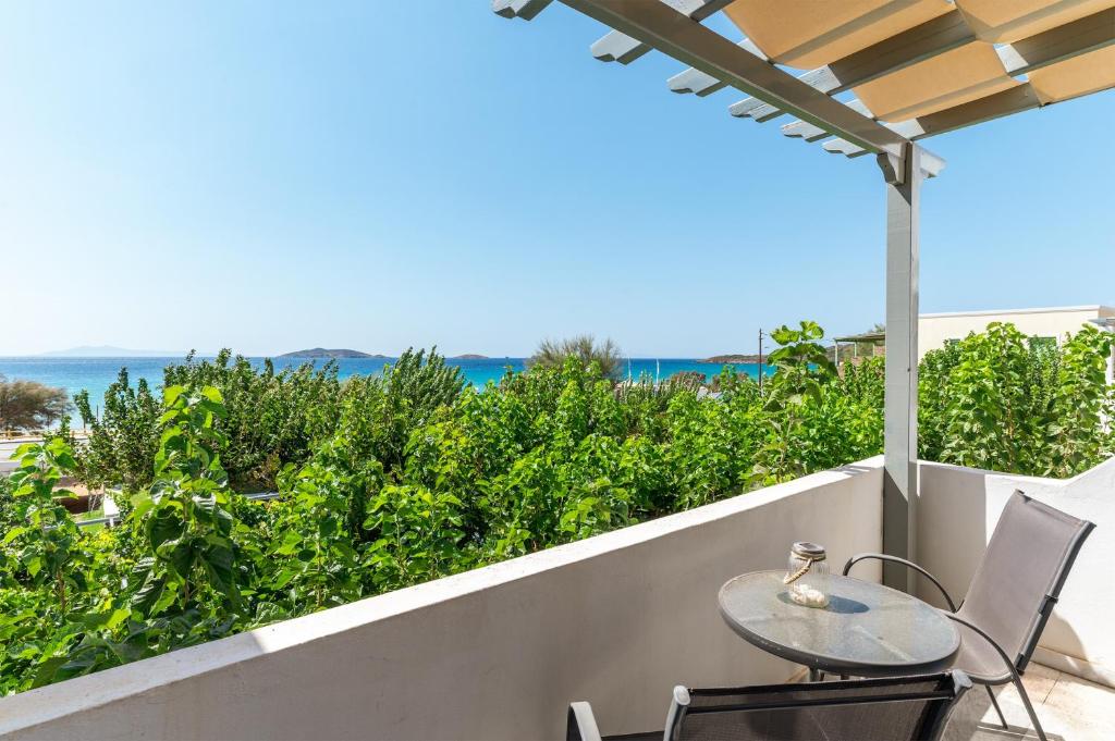 a table and chairs on a balcony with a view of the ocean at Perasma Studio 1a in Kipri