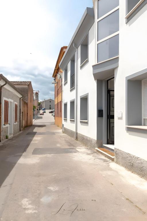 an empty alley between two buildings at Lu Furru Apartments in Telti