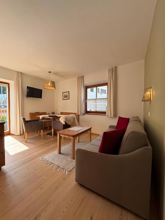 a living room with a couch and a table at Ferienwohnungen Zwick Spinei in Malles Venosta
