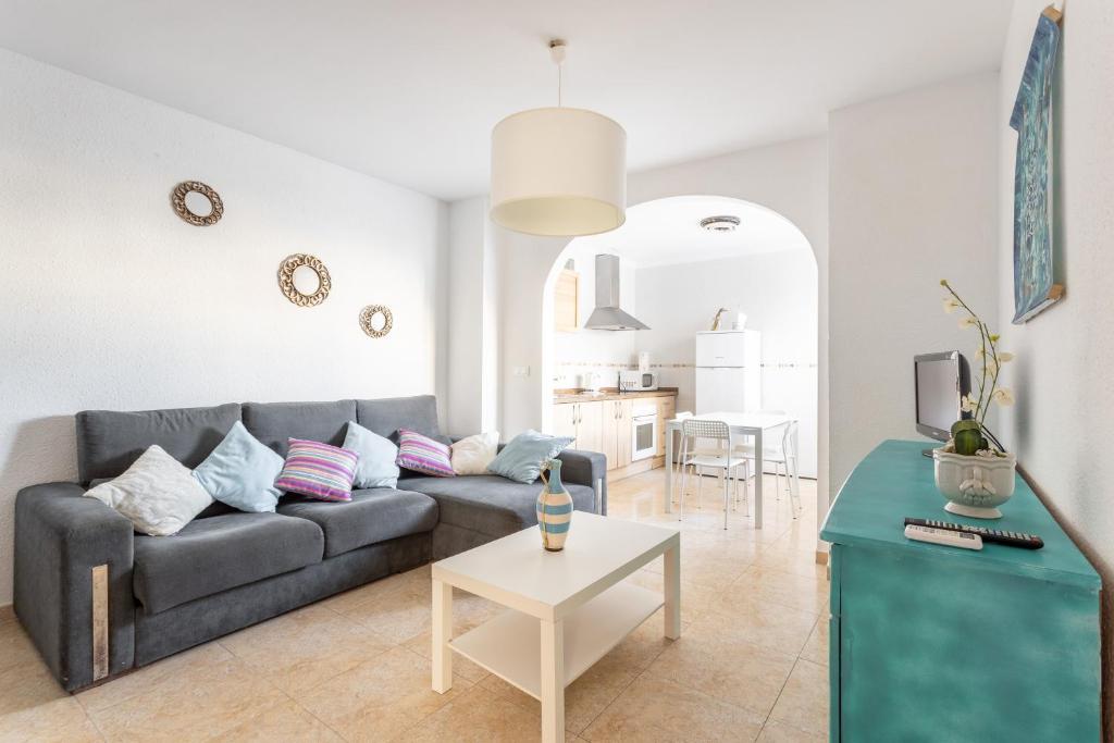 a living room with a couch and a table at Apartamento Turquesa Nerja in Nerja
