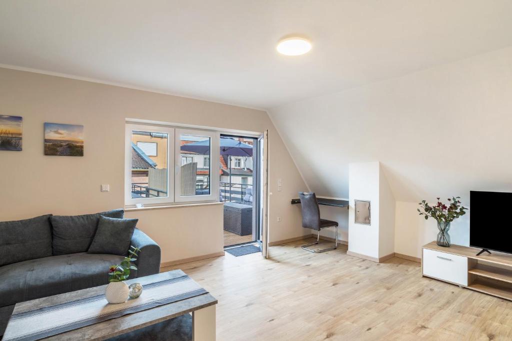 a living room with a couch and a tv at Unique Apartments Wiesloch in Wiesloch