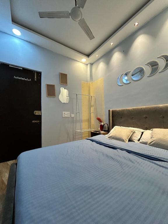 a bedroom with a large bed with a ceiling fan at Faaloon 102 in Chennai