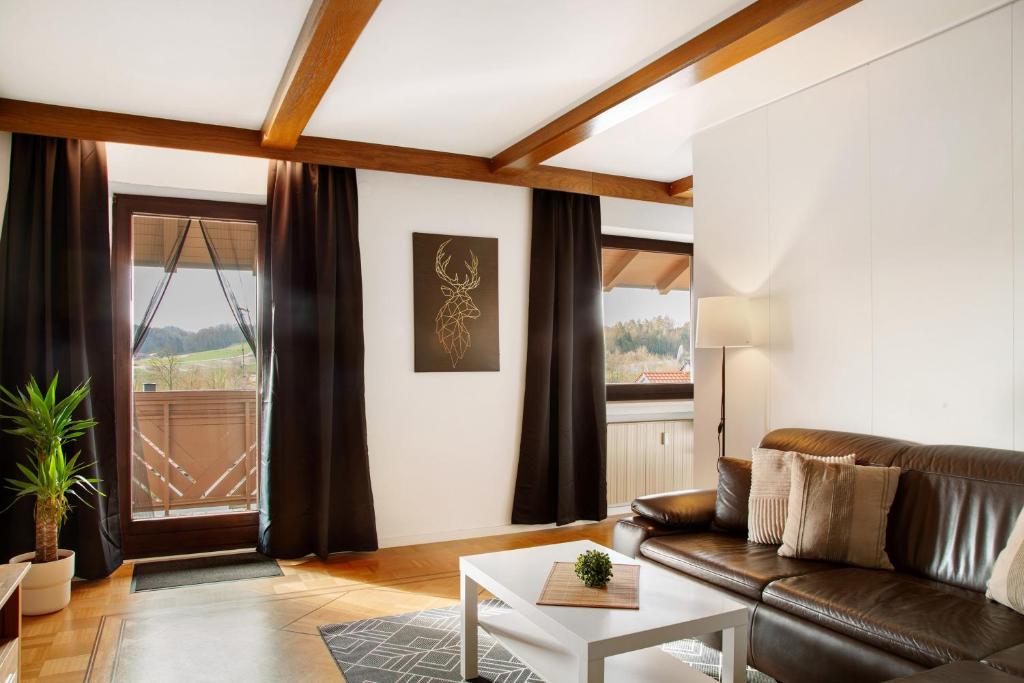 a living room with a couch and a table at Weinberg in Zeilarn