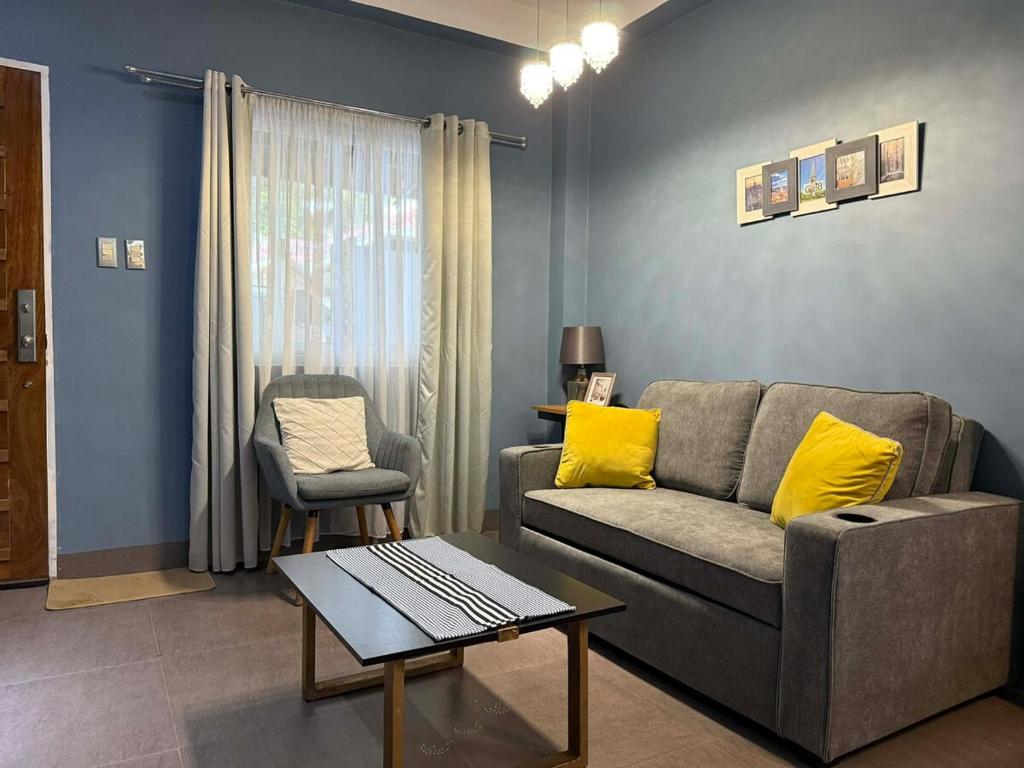 a living room with a couch and a table at Luxea Flexstay II - Spacious Duplex Home in San Francisco