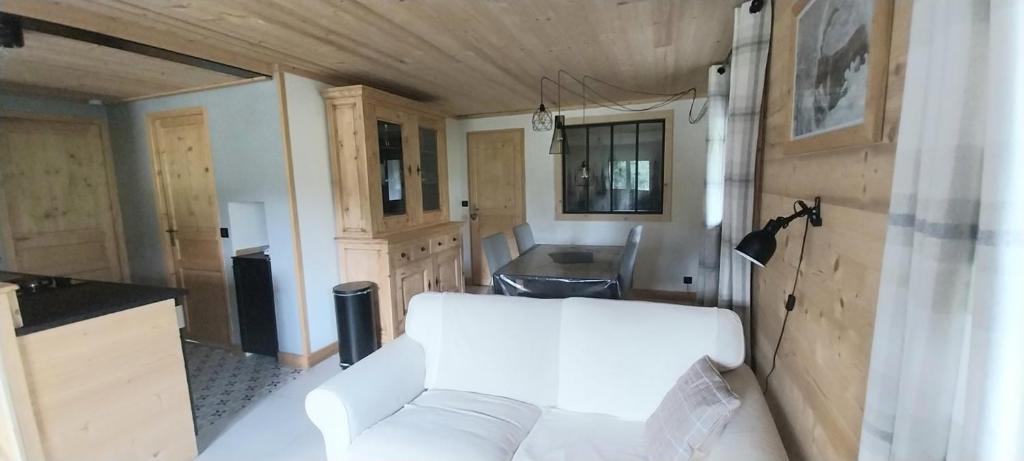 a living room with a white couch in a trailer at Gite Cairn, Rez De Chalet in Faverges