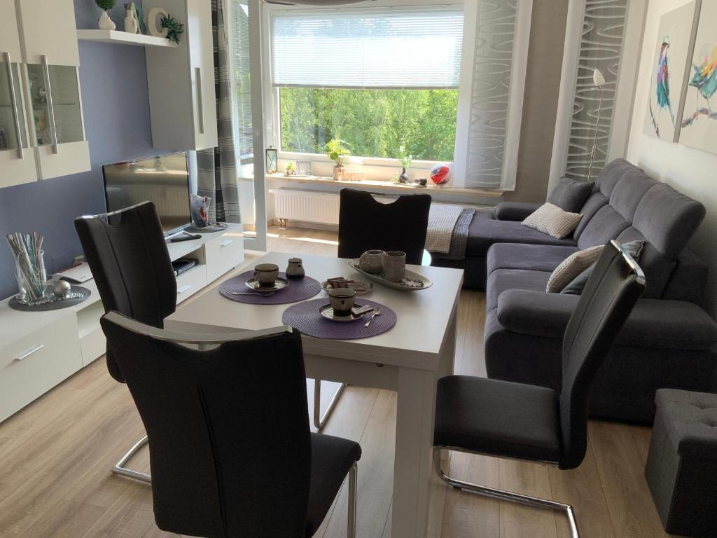 a living room with a couch and a table and chairs at Fuchsenstein 44 in Oberkreuzberg