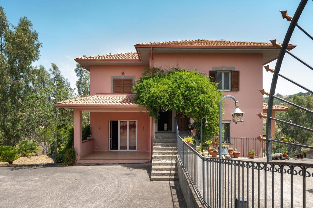 a pink house with a fence in front of it at Villa Filippa in Nicosia