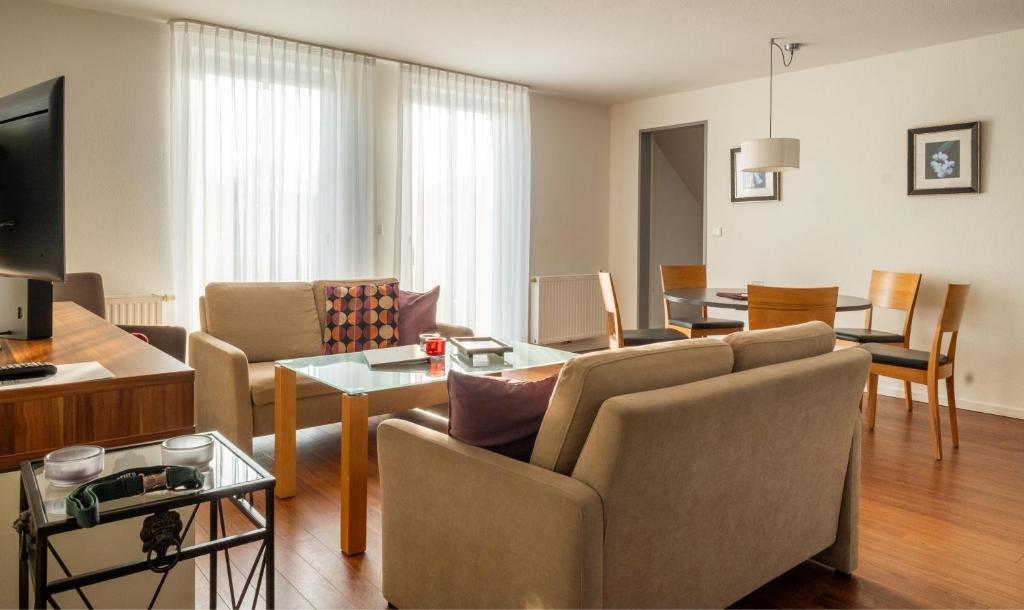a living room with a couch and a table at Ferienhaus Jümmers - Sönke in Horumersiel