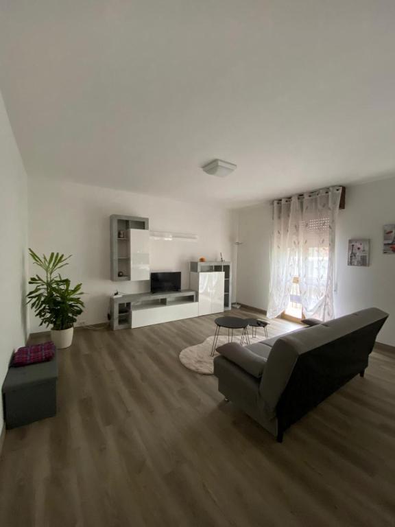 a living room with a couch and a table at Appartamento Primavera in Cazzago San Martino