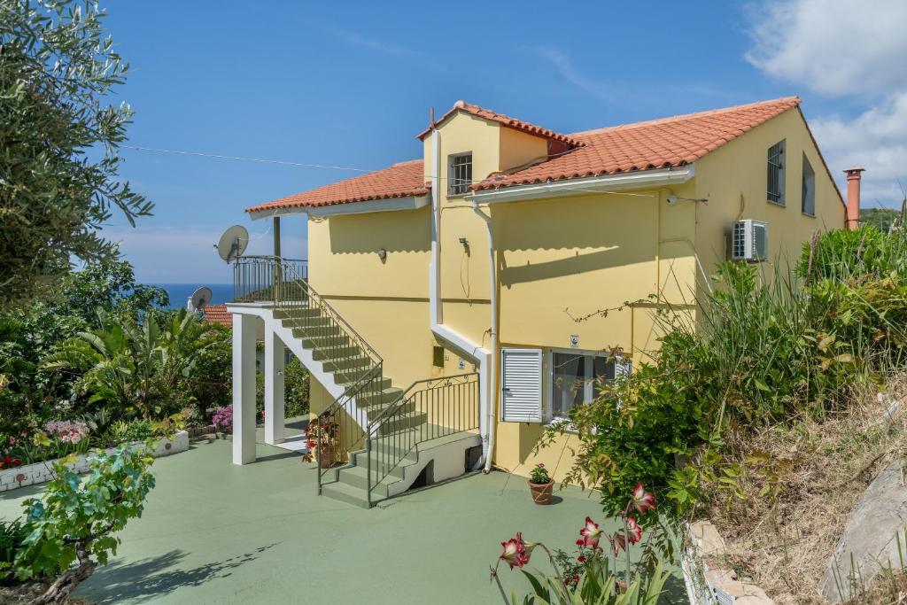 a house with a staircase in front of it at Palati in Kefallonia