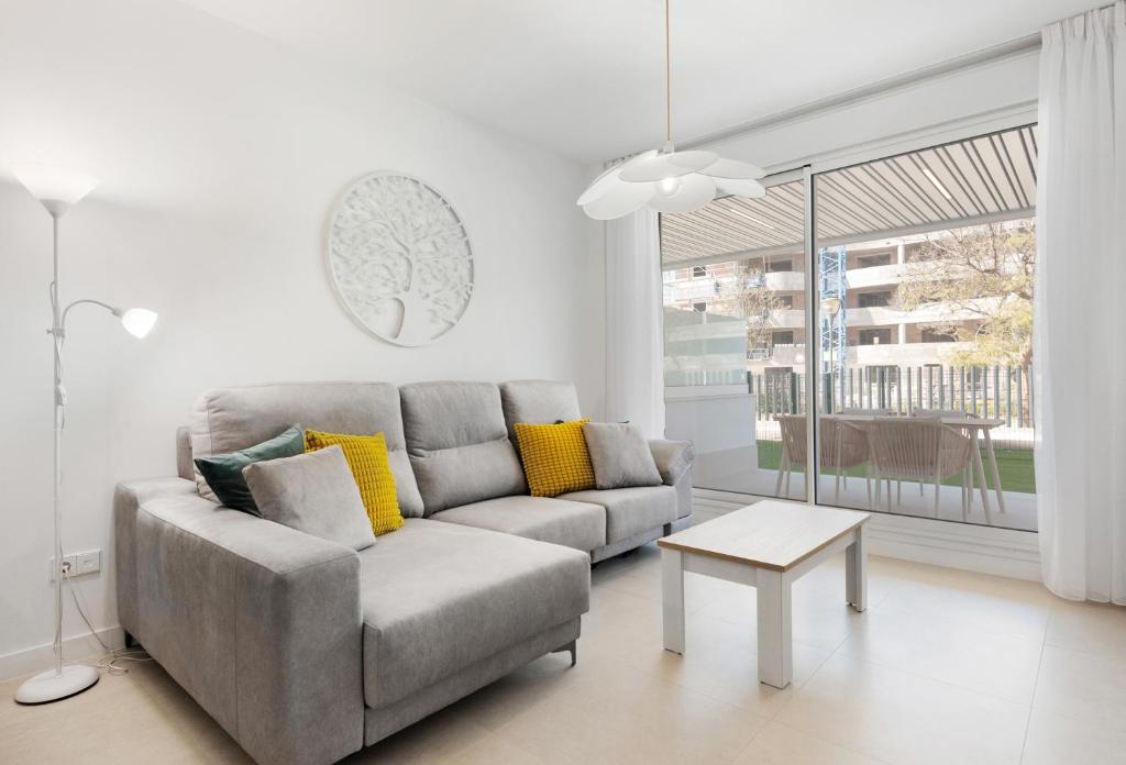 a living room with a couch and a table at Horus 054 in Torre del Mar