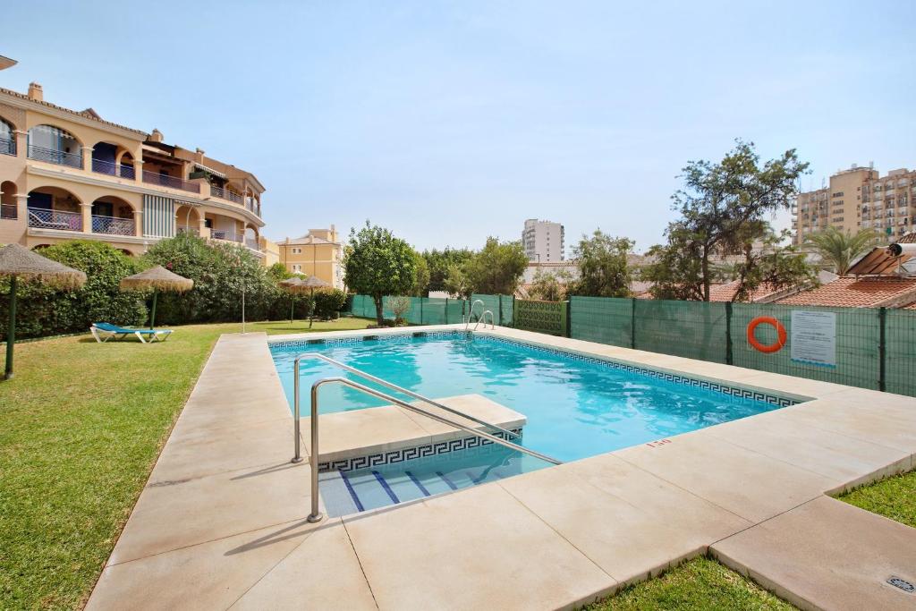 a swimming pool in the backyard of a building at Prealsa Benalmádena in Benalmádena
