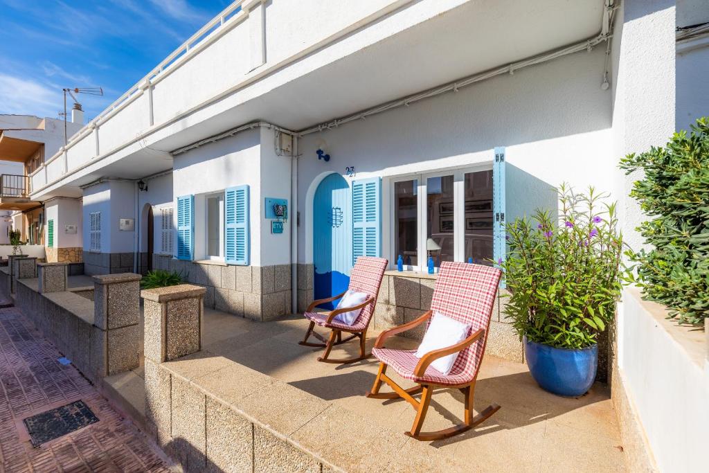 two chairs sitting on a porch of a house at Can Blau in Portocolom