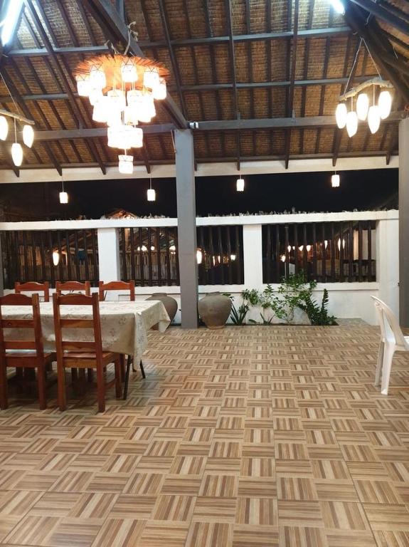 a dining room with a table and chairs and a ceiling at Beachhouse for 15 pax with pavilion in Nasugbu