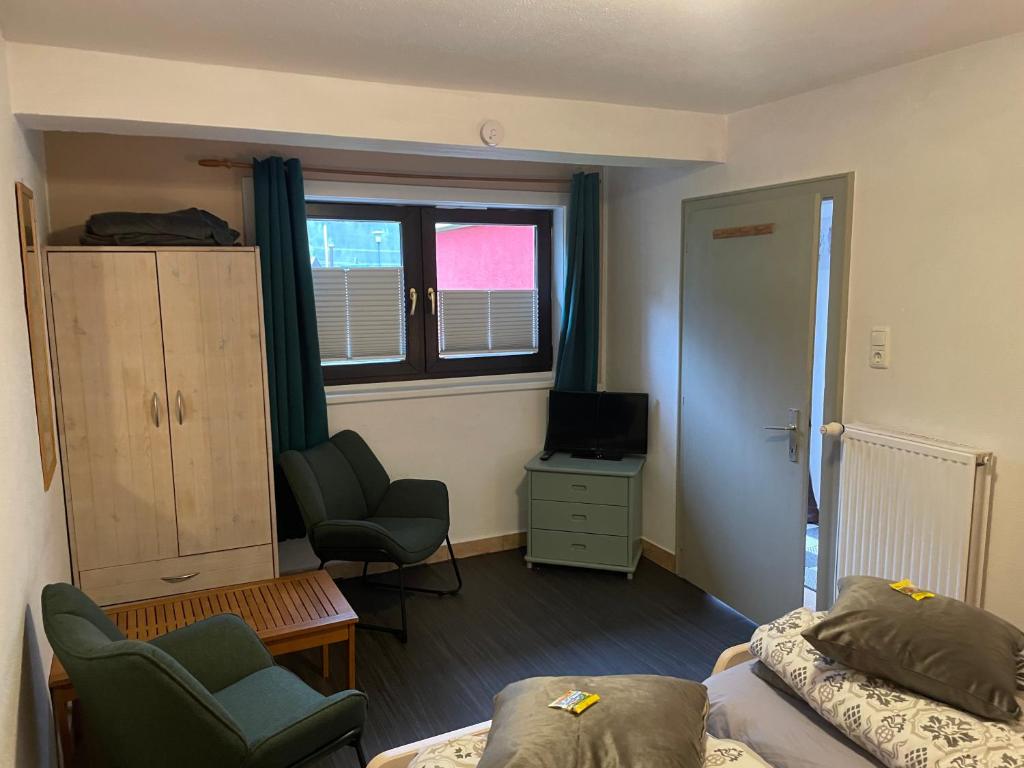 a room with a bed and a chair and a window at Studio Pepper in Stall